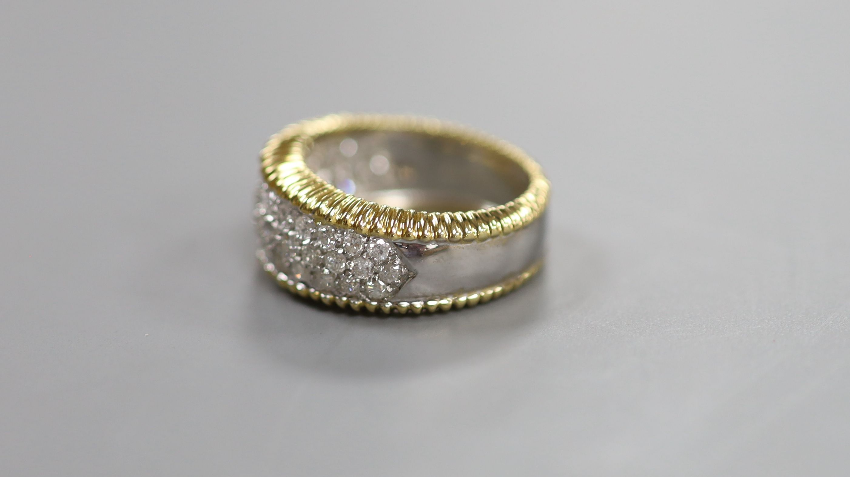 A modern 18ct gold and pave set diamond dress ring